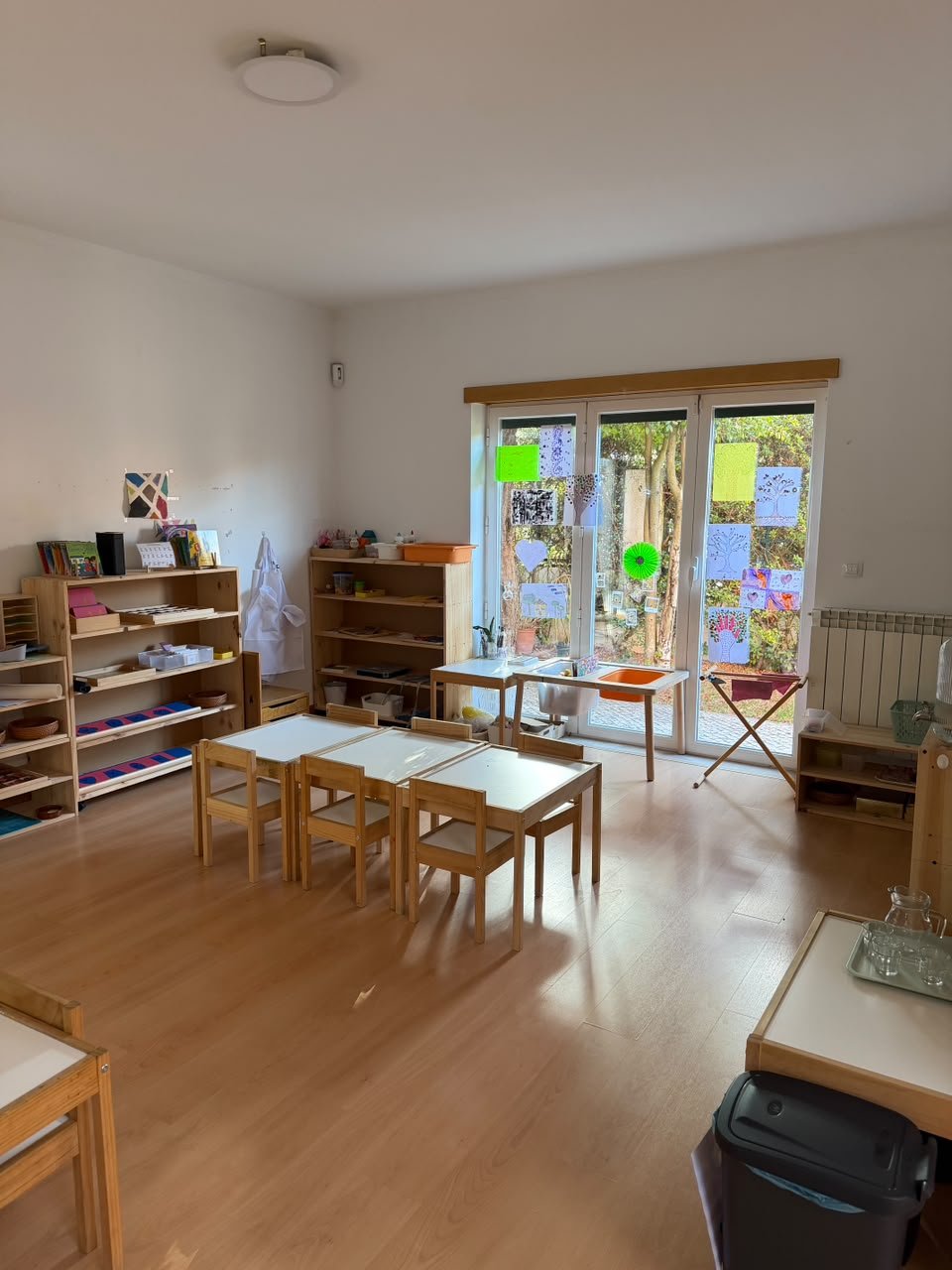 Prepared Montessori classroom with wooden materials and natural light